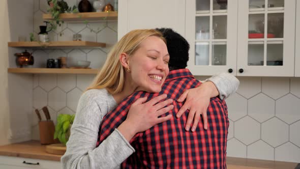 Happy Multiethnic Family Love Couple Hugging at Home Kitchen Woman and Man