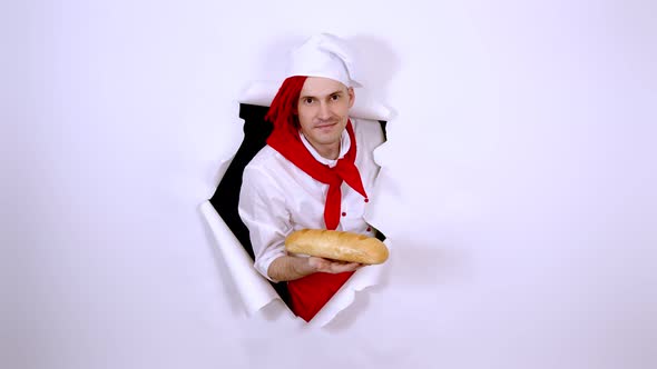 Young Man with Red Dreadlocks Dressed As Chef Holding White Bread