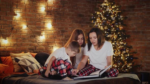 Mom Reads Bedtime Story To Children Indoors