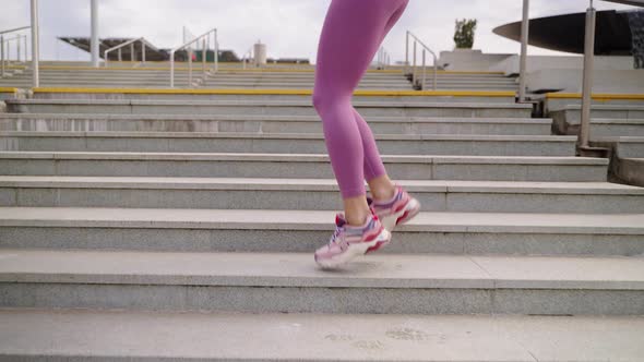 Sportswoman is Jumping Over Stairs Training Legs Muscles Closeup of Feet