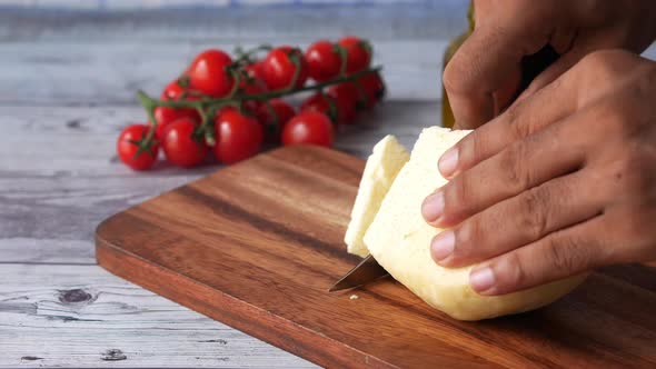 Close Up of Men Cutting Fresh Cheese on Table