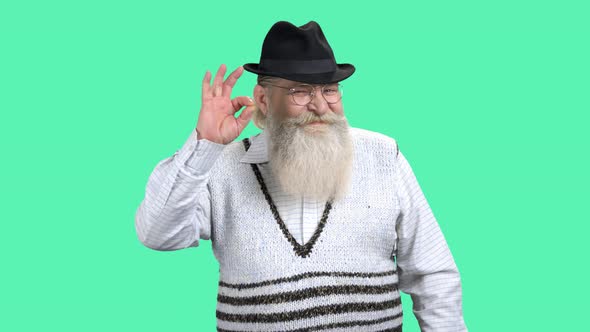 Senior Man Showing Ok Symbol on Color Background