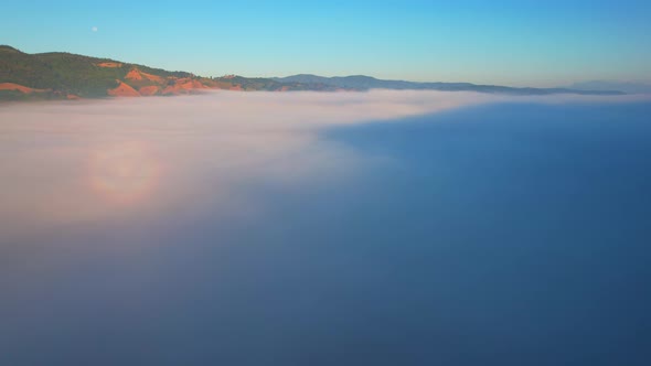 4K Aerial Flying Above Sea of Fog at Sunrise