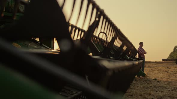 Agronomist Silhouette Rest Wheat Farmland Lean Harvester Machine Golden Sunset