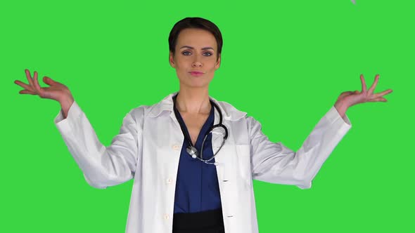 Beautiful Young Doctor Throwing Paper on a Green Screen, Chroma Key.