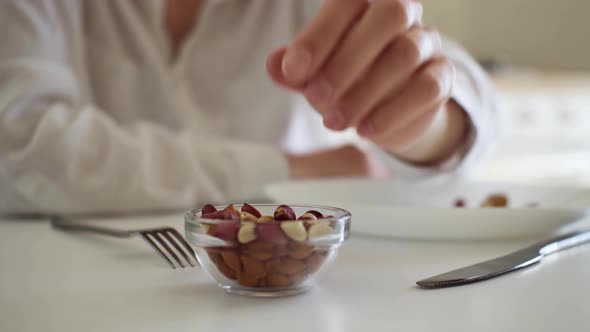 Close Up Of A Hand Takes Peanuts, Peanut Nuts Close Up Of A Bowl Of A Plate Of Peanuts