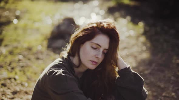 Slow motion shot of redheaded woman looking away