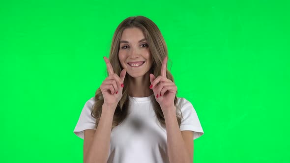 Lovable Girl Smiling and Showing Heart with Fingers Then Blowing Kiss. Green Screen