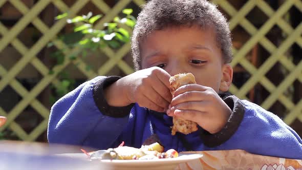 Boy Is Greedily Eating Chicken.