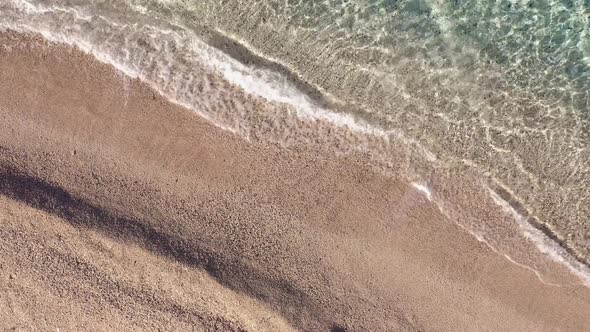 Aerial View of Sandy Beach and Transparent Ocean Water