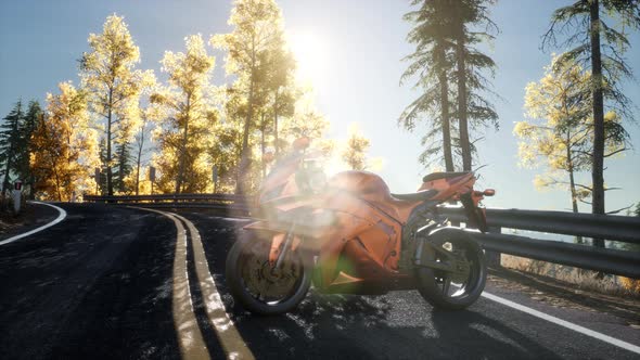 Sportbike on Tre Road in Forest with Sun Beams