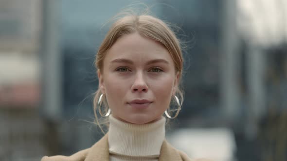 Positive Woman in Formal Clothes Standing on City Street