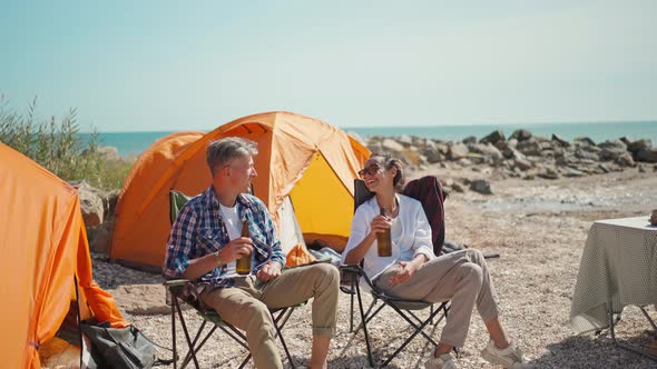 Beautiful Woman in White Shirt and Handsome Man in Casual Shirt and Jeans Drinking Cold Beer at Hot