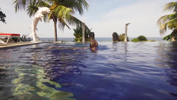 Girl Is Swimming in the Pool