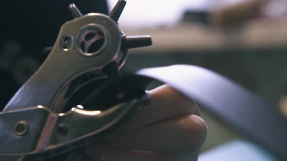 Skilled Tailor Makes Holes with Special Punch Pliers