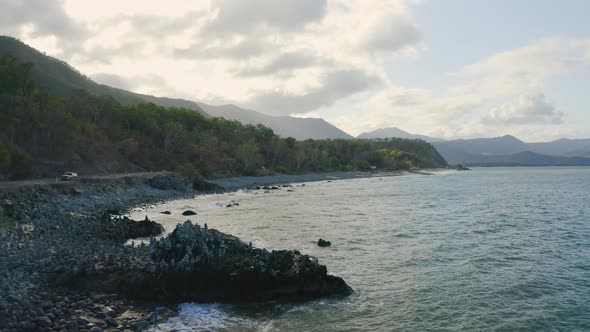 A Road By The Ocean Side With Balancing Stone