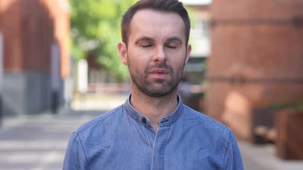 Portrait of Sad Casual Man Looking at Camera