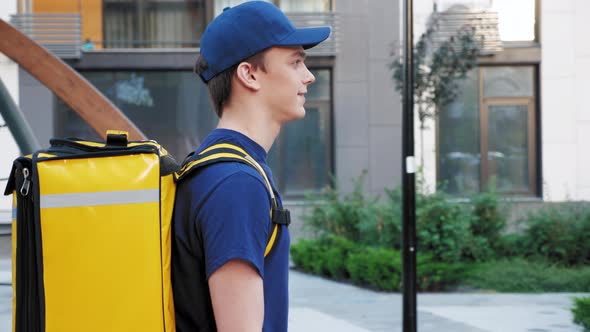 Side View Close Up Smiling Food Delivery Man Courier with Thermal Backpack