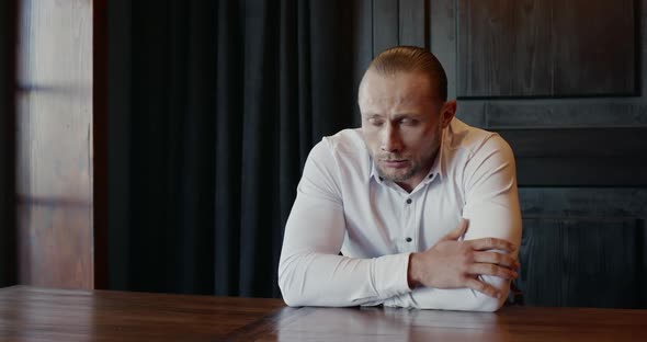 Nervous Man Waiting for Job Interview at Table