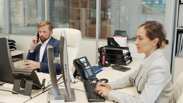 Businesspeople in Formal Wear Working in Office