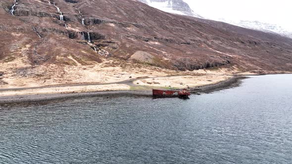 World War 11 US Navy LCM Wrecked Vessel In Mjoifjordur, East Iceland. Orbiting Drone Shot