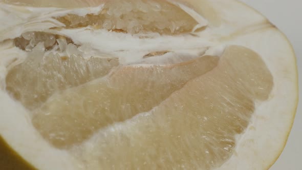 Shallow DOF of cutted pomello fruit close-up 4K 2160p 30fps UltraHD  tilting footage - Two halves of