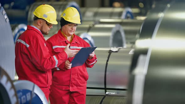 Team of Engineers Having Discussion on Industrial Steel Plant