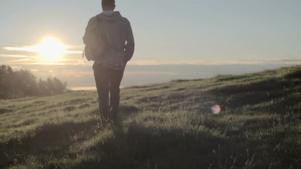 Young Man Hiking Away in Mountain Outdoor Nature Scenery During Summer Sunrise or Sunset