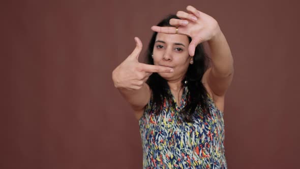 Creative Indian Model Pretending to Take Picture in Studio