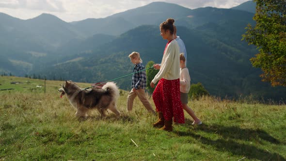 Parents Kids Walking Dog on Mountain Hill
