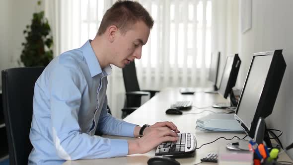 Young Handsome Man Works on Desktop Computer and Computer Broken Down in the Office