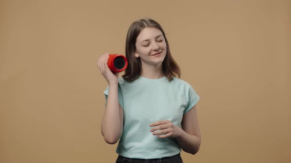 Portrait of Charming Beauty Model Listening to Music with Bluetooth Portable Speaker and Dancing