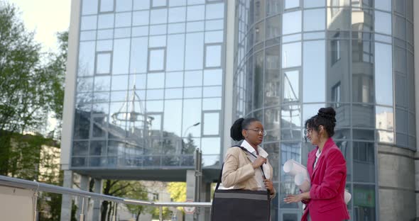 Female Architects Talking About Project at Glass Building