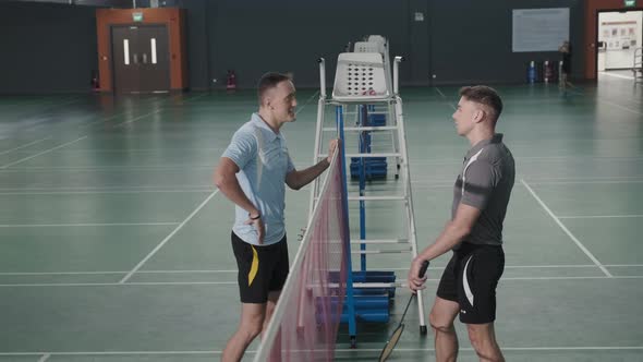 Two Tennis Players Chatting and High Fiving on Court