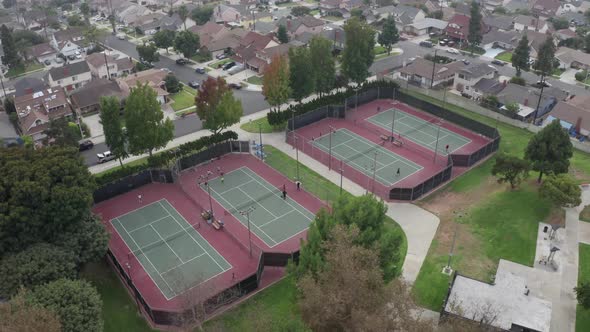 Aerial View of four tennis courts in residential neighborhood