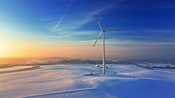 Wind turbine on snowy field. Alternative energy. Aerial view, Poland