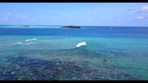 Aerial drone shot nature of idyllic coast beach vacation by blue ocean with bright sand background o