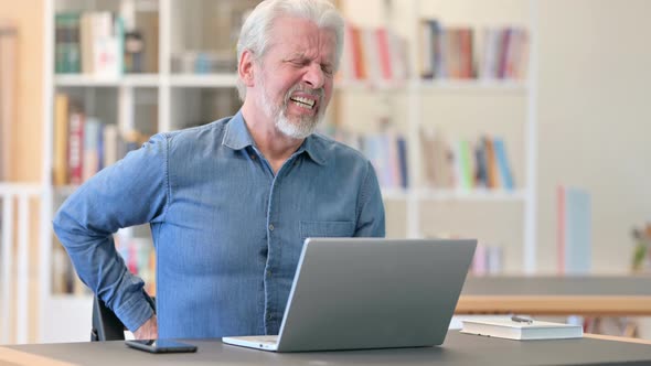 Old Man with Laptop Having Back Pain at Work