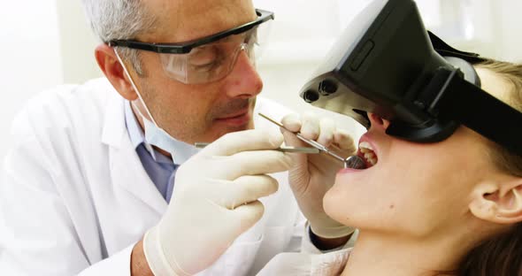 Female patient using virtual reality headset during a dental visit