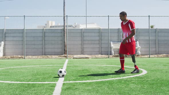 Soccer player with prosthetic leg on field