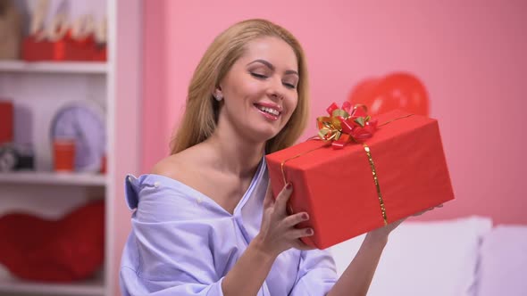 Attractive Smiling Lady Holding Gift Box Delighted With Surprise, Valentine Day