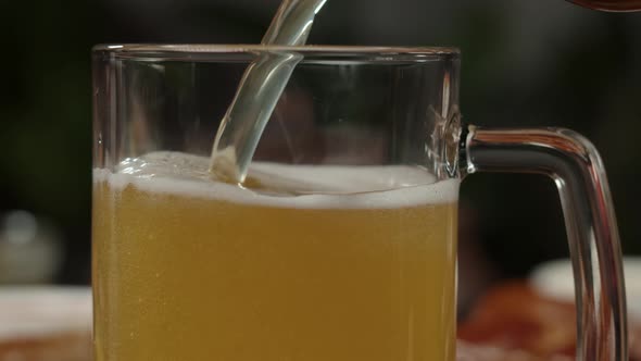 Pouring Frothy Beer in Glass Closeup