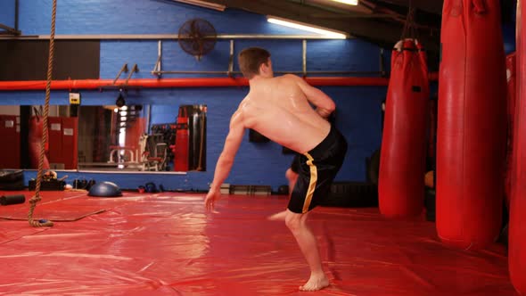 Boxer practicing boxing with punching bag
