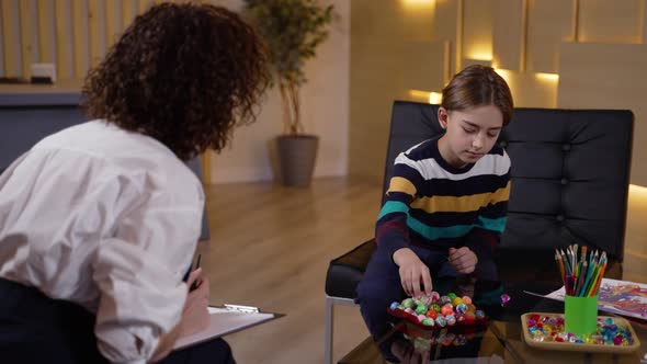 Therapist Using Colored Balls to Test Kid Patient