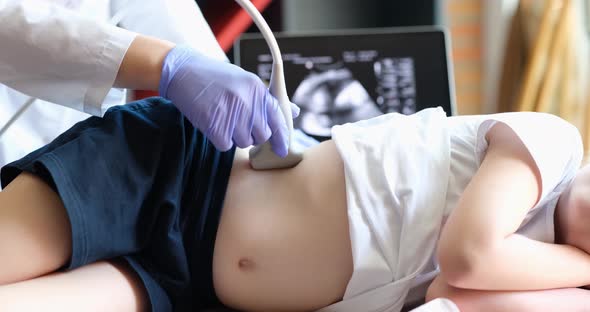 The Doctor Makes an Ultrasound of the Abdomen of a Child