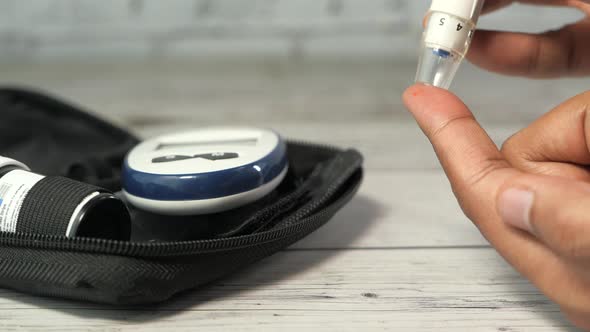 Young Man's Hand Measure Glucose Level at Home 