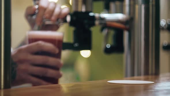 Barman Pouring Lambic Into Glass Closeup Foamy Cherry Beer