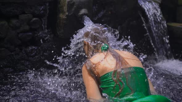 Slowmotion Shot of a Young Woman Visiting the Holly Springs in Indonesia. Tirta Empul Holy Water