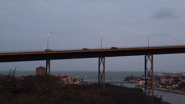 Camera car chase over the the Juliana Bridge enterance of the Sint Anna Bay and a cruise ship at the