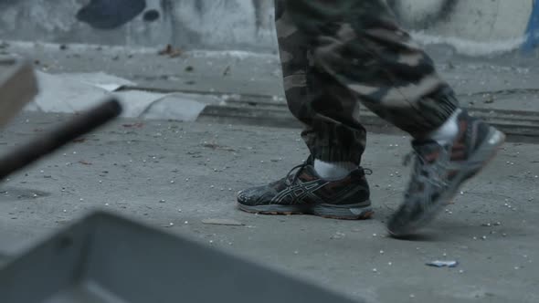 The feet of a personal trainer man before doing a workout inside an abandoned building.